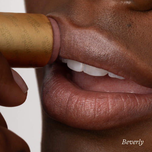 Girl using Beverly lip tint on her lips up close. 