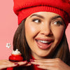 Girl holding Candy Cane Fluff lip scrub with gold spatula. , 2 of 3