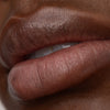 Up close of Daisy lip tint on model's lips., 6 of 7