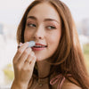 Up close of girl using French Macaron lip balm on their lips., 3 of 8