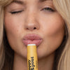 Women Using Poppy & Pout Lemon Bloom Lip Balm, 3 of 5