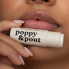 Women Holding Poppy & Pout Marshmallow Lip Balm, 4 of 5