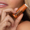 Women Holding Poppy & Pout Orange Lip Balm, 6 of 6