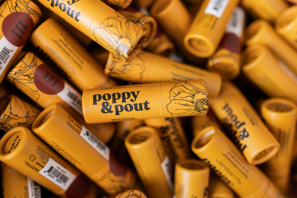 Pile of Poppy & Pout Wild Honey Lip Balms. 