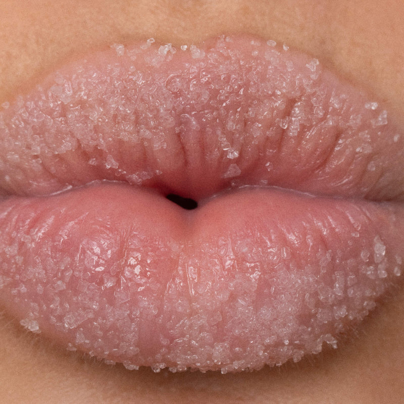 Woman Exfoliating Lips with Sugar Scrub