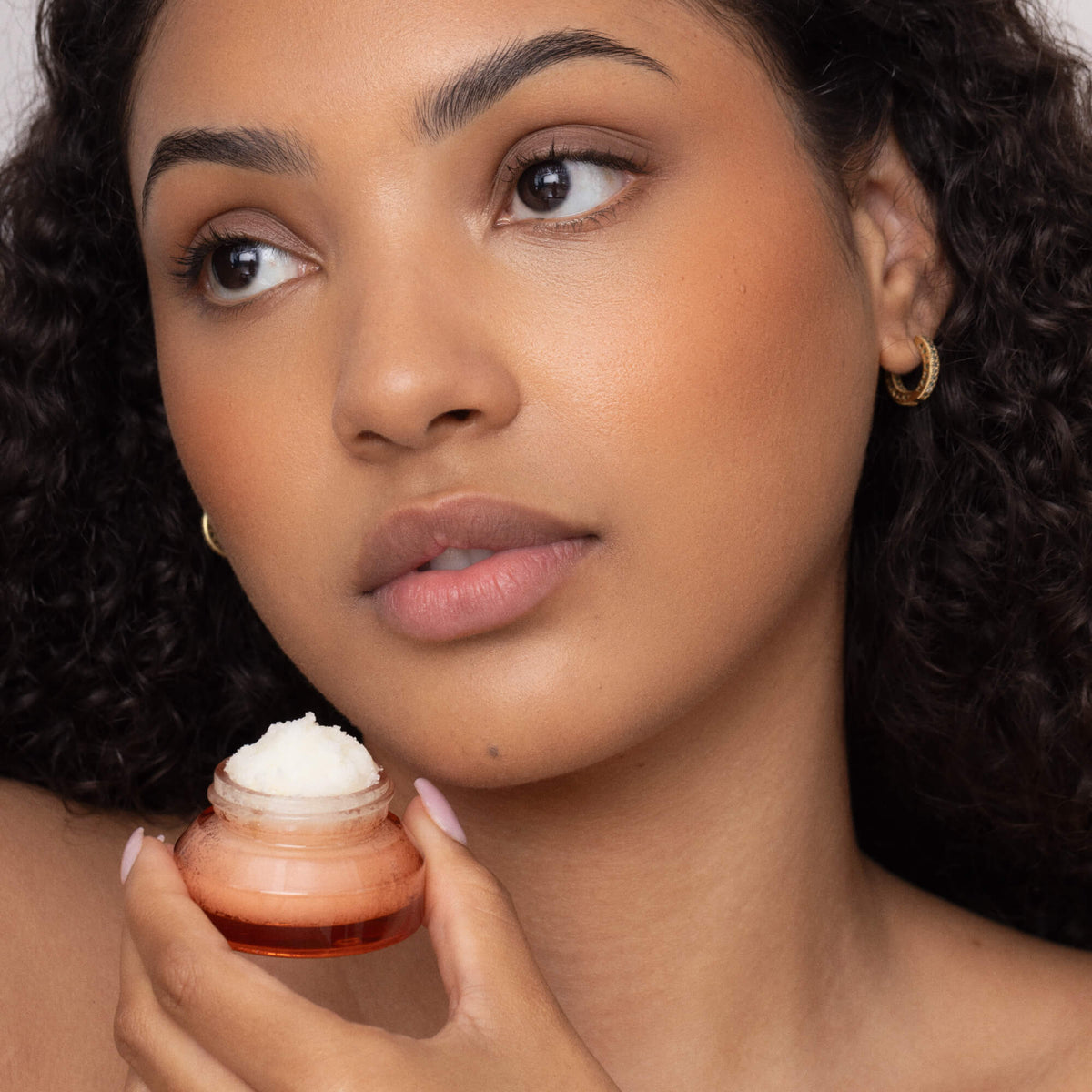 Women Holding Poppy & Pout Pomegranate Peach Lip Scrub