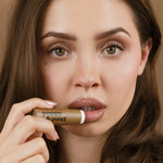 Vanilla Chai lip balm tube on lips, brown tube, 5 of 5