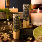 Practical Magic lip balm sister pack tubes with gold caps standing on a table, 4 of 7