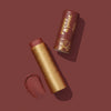 Poppy & Pout Roxie lip tint with lid off on a burgundy background and swatch, 2 of 7