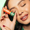 Girl holding Sugared & Spiced lip balm., 4 of 6