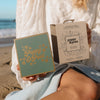 Woman Sitting near Beach and Showing Island Coconut Lip Care Duo Gift Set, 4 of 5